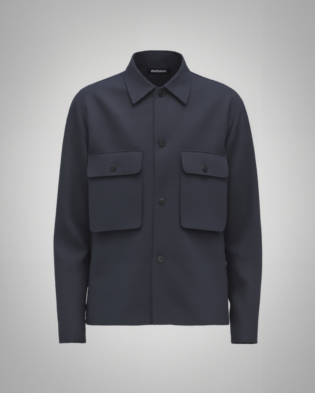 Navy blue cotton twill utility overshirt with a relaxed fit. Features a four-button front closure, two oversized flap pockets, refined topstitching, and a soft matte finish. Fully lined for added structure and durability. Designed for effortless layering and cut and sewn in Australia.