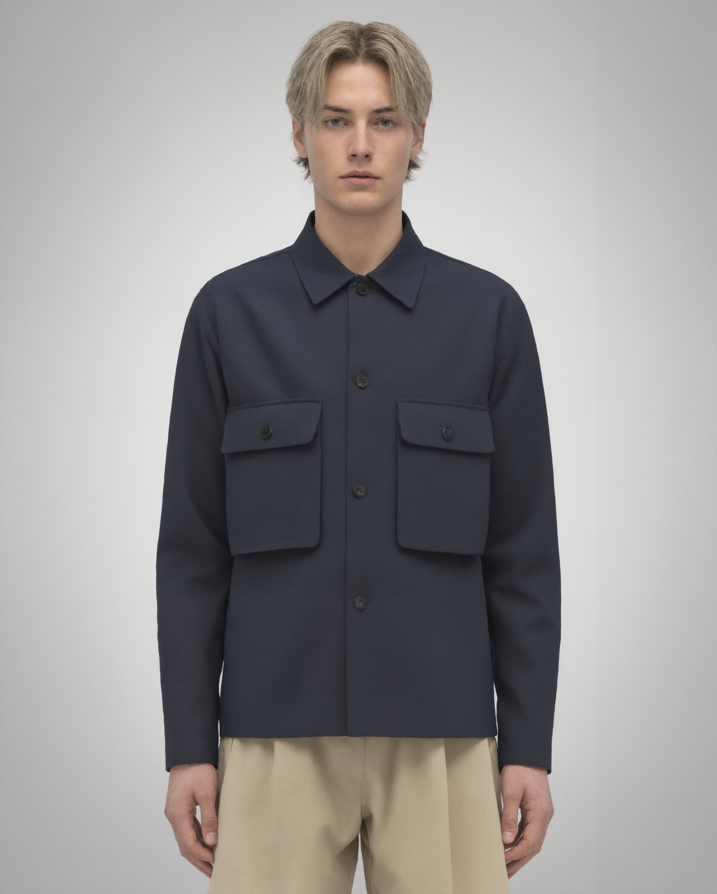 Navy blue cotton twill utility overshirt with a relaxed fit. Features a four-button front closure, two oversized flap pockets, refined topstitching, and a soft matte finish. Fully lined for added structure and durability. Designed for effortless layering and cut and sewn in Australia.