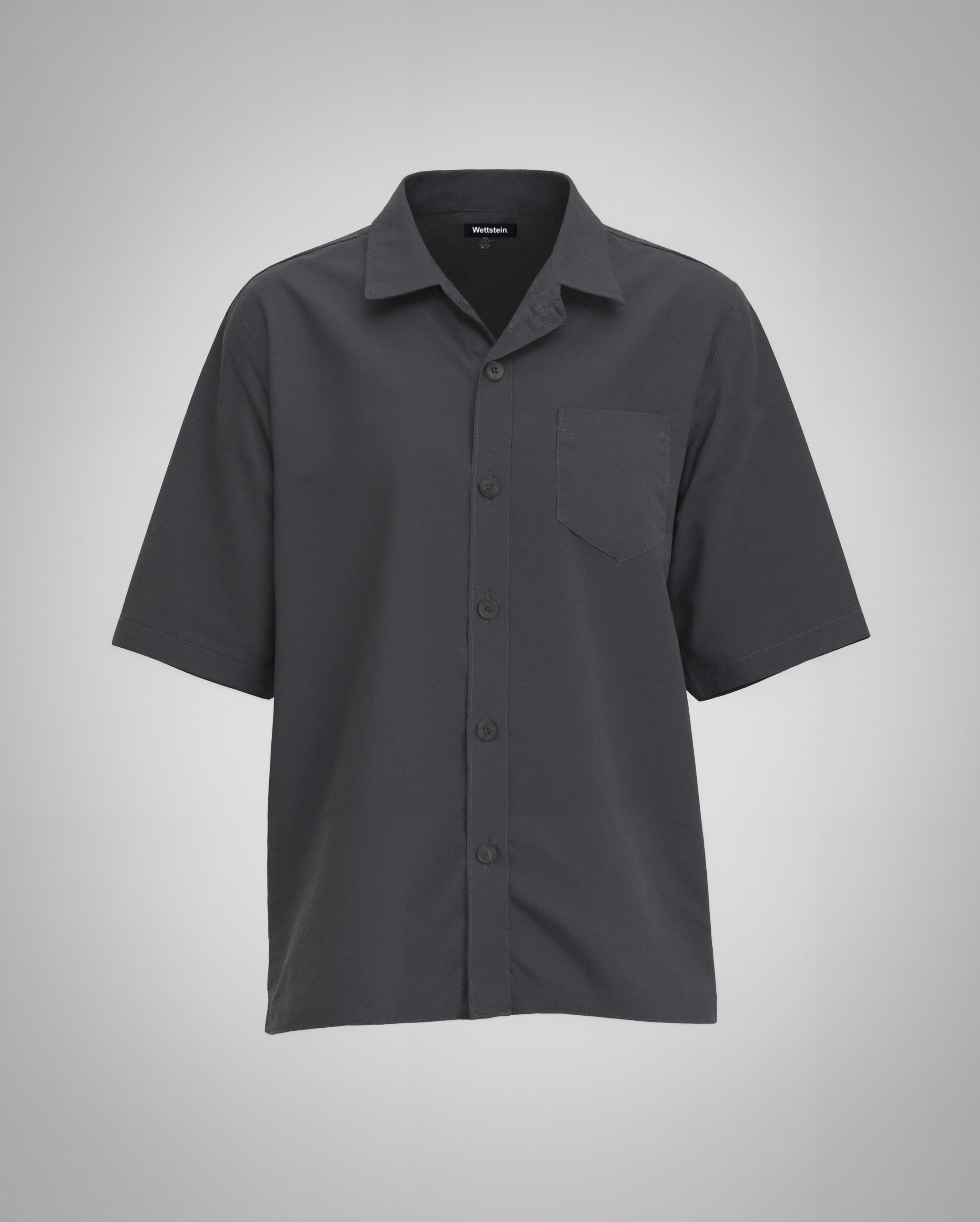 A black short-sleeve button-up shirt with a regular fit, made from 100% organically grown cotton. Designed with a structured spread collar, a single square chest pocket with precise topstitching, and a clean five-button front closure with tonal matte black buttons. The lightweight fabric has a soft matte finish, creating a refined yet relaxed silhouette.